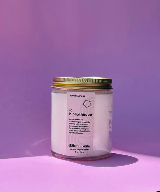 La bibliothèque luxury soy wax candle in clear glass and gold lid jar. 